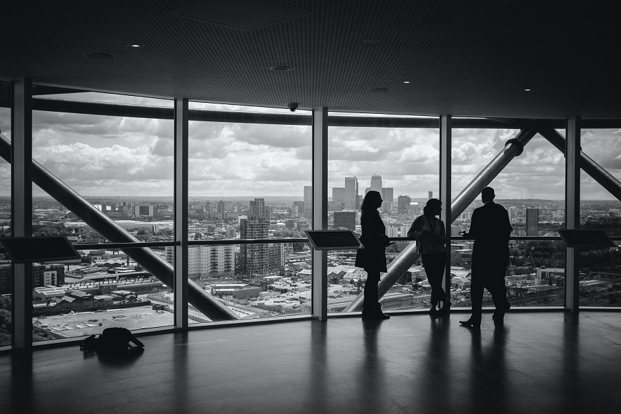 People talking by skyscraper windows